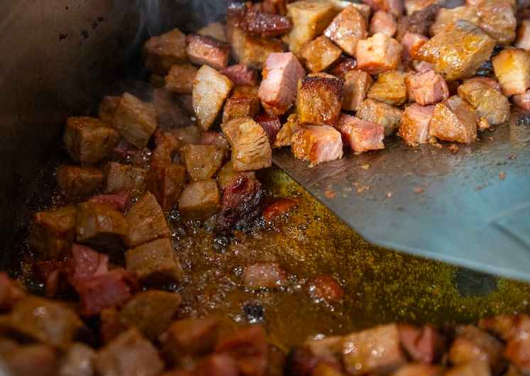 Andouille sausage and chicken browning in a Dutch oven—the first step in building bold Cajun  jambalaya flavor.